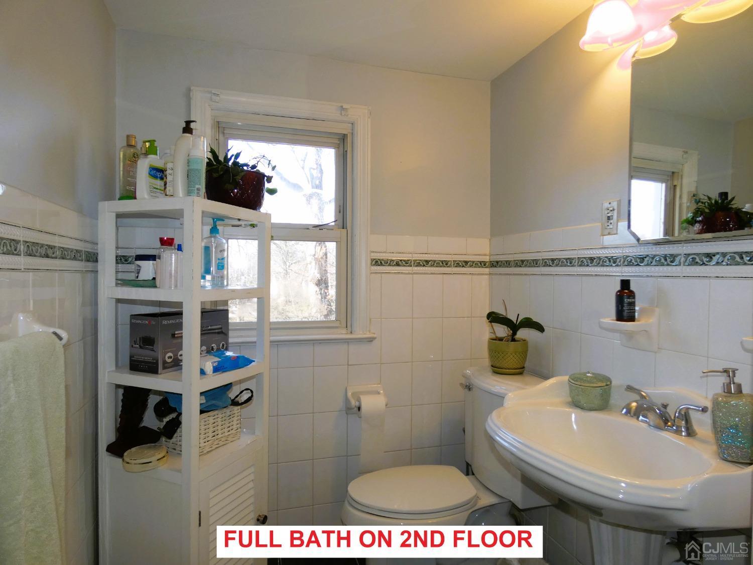 412 Chain O' Hills Road Colonia, NJ 07067 - Photo 23 of 34 a bathroom with a sink a toilet and a mirror