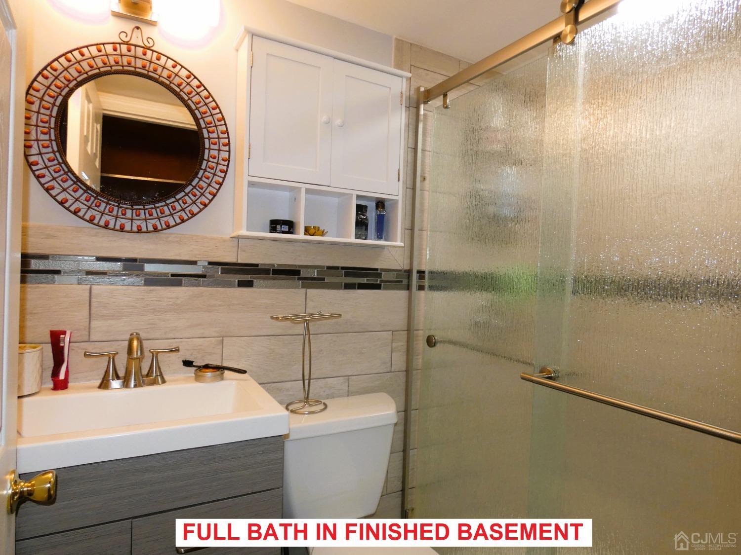 412 Chain O' Hills Road Colonia, NJ 07067 - Photo 24 of 34 a bathroom with a sink a mirror and a shower
