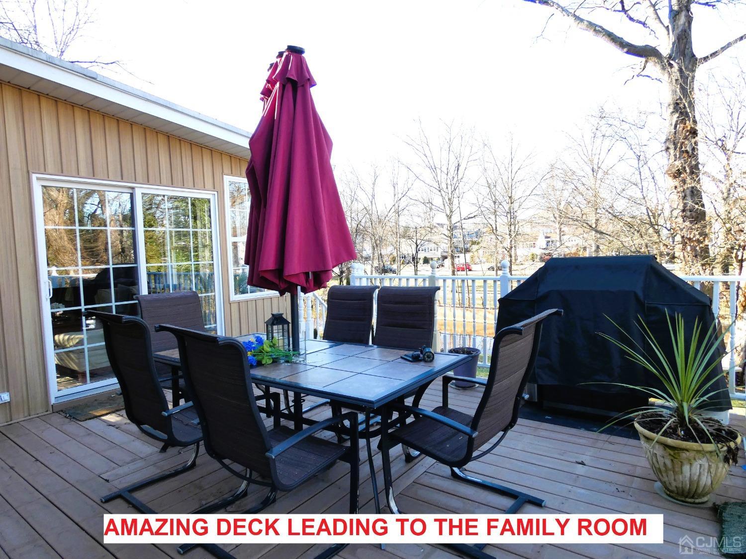 412 Chain O' Hills Road Colonia, NJ 07067 - Photo 26 of 34 a view of a dining table and chairs on the deck