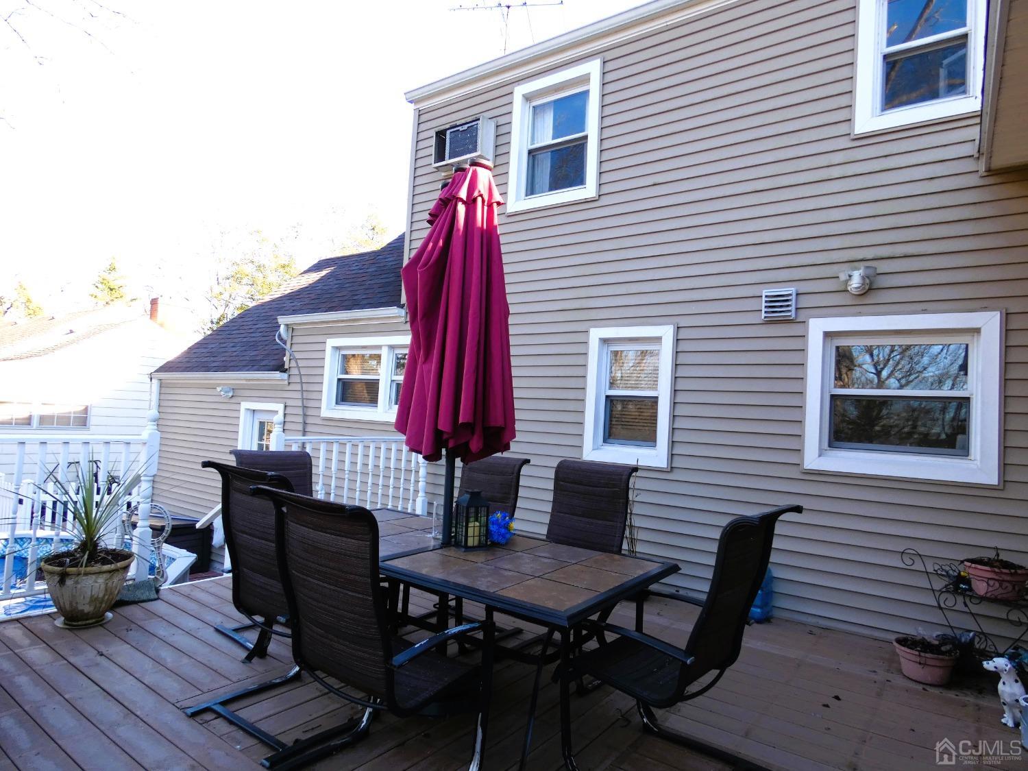412 Chain O' Hills Road Colonia, NJ 07067 - Photo 27 of 34 a dinning table and chairs in front of a house