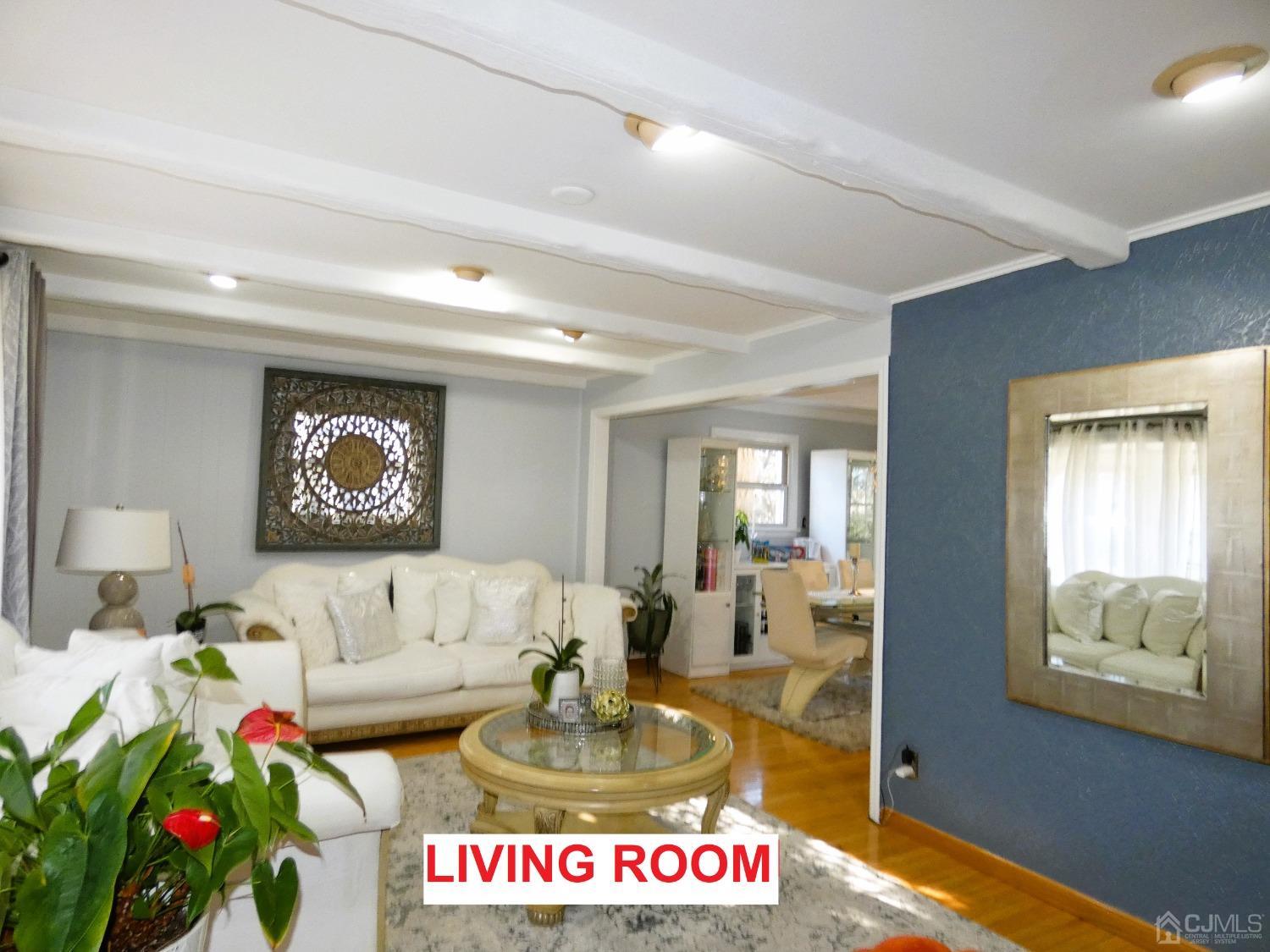 412 Chain O' Hills Road Colonia, NJ 07067 - Photo 3 of 34 a living room with furniture and a flat screen tv