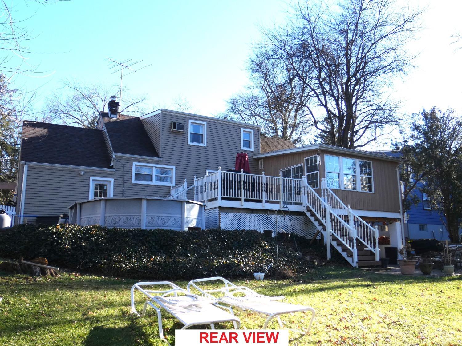 412 Chain O' Hills Road Colonia, NJ 07067 - Photo 32 of 34 a front view of a house with a yard