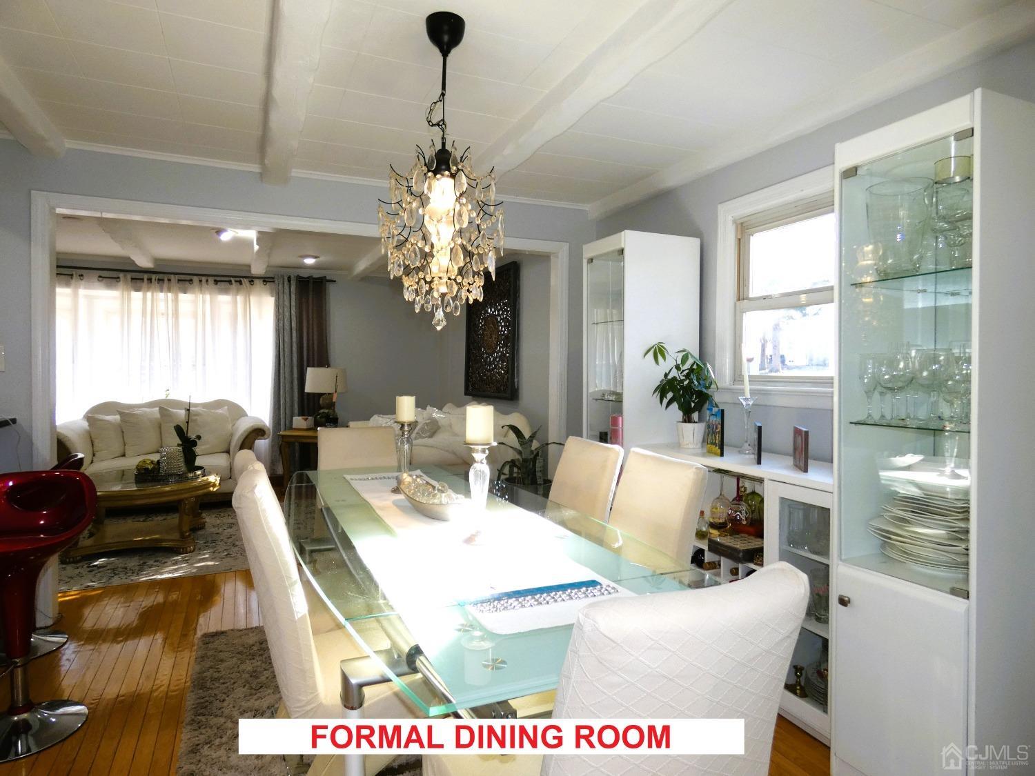 412 Chain O' Hills Road Colonia, NJ 07067 - Photo 8 of 34 a living room with furniture chandelier and a large window