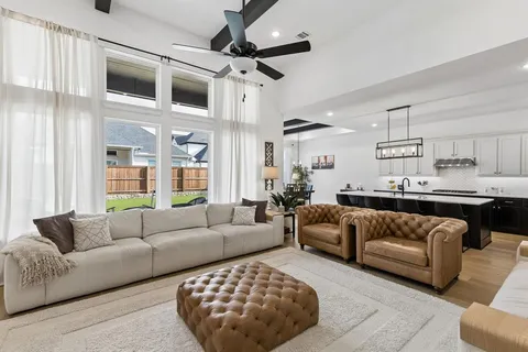 a living room with furniture ceiling fan and a rug