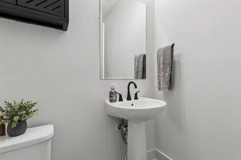 a bathroom with a sink a mirror and a toilet