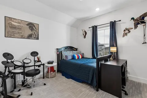 a bedroom with furniture and a window