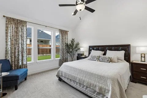 a bedroom with a bed couch and window