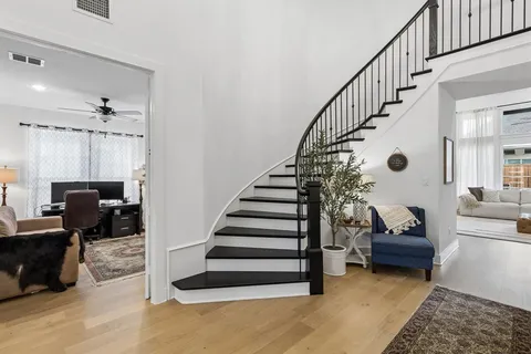 a living room with furniture and stairs