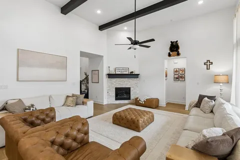 a living room with furniture kitchen view and a fireplace