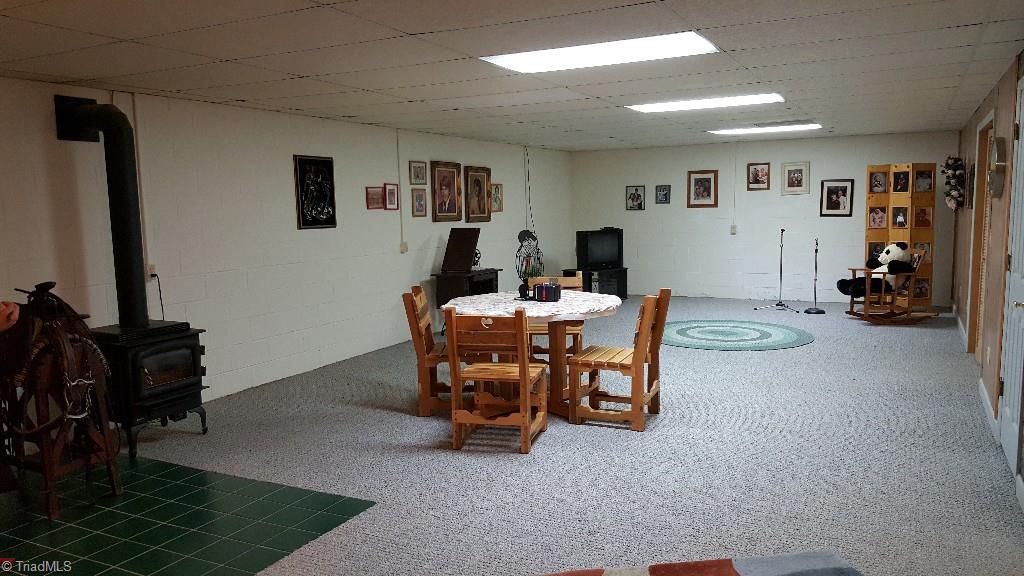 1477 Tillotson Road Pinnacle, NC 27043 - Photo 16 of 17 Large family room in basement with extra heat source, propane gas stove