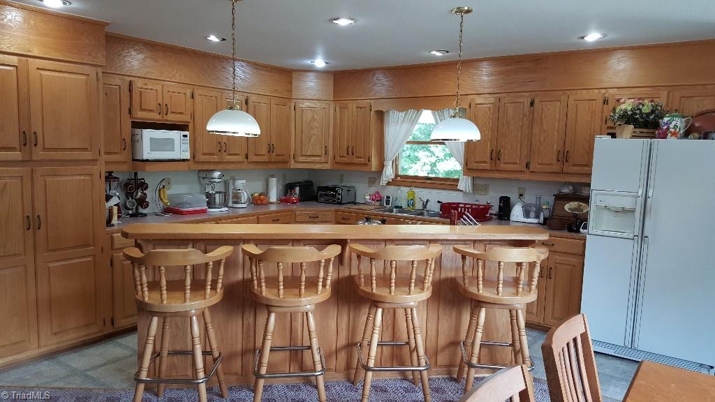 1477 Tillotson Road Pinnacle, NC 27043 - Photo 8 of 17 Open dining/kitchen with island bar