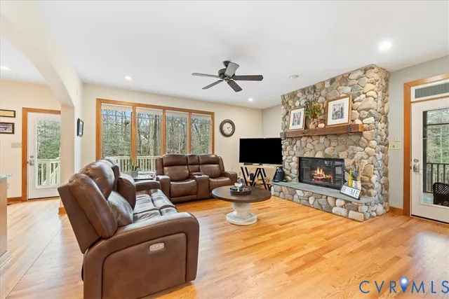 a living room with furniture a fireplace and a flat screen tv