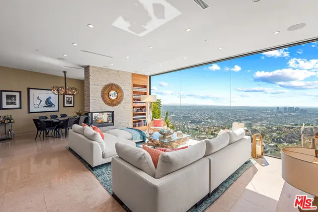 a living room with furniture and a floor to ceiling window