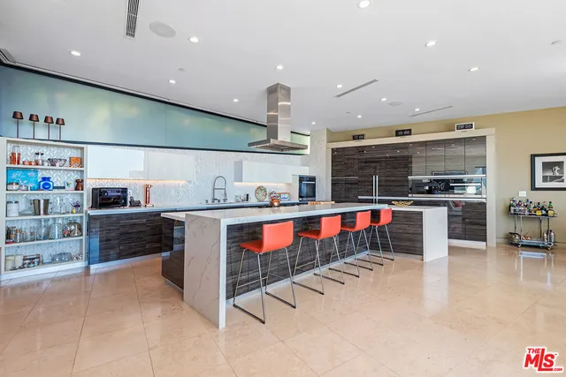 a kitchen with stainless steel appliances kitchen island granite countertop a sink and cabinets