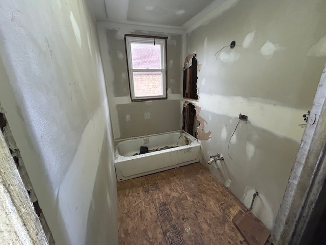 10230 South Union Avenue Chicago, IL 60628 - Photo 12 of 28 a bathroom with a tub sink and mirror