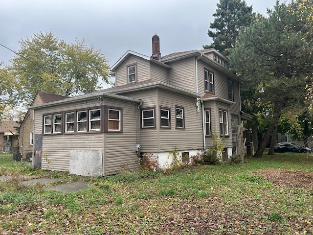10230 South Union Avenue Chicago, IL 60628 - Photo 4 of 28 a front view of a house with a yard