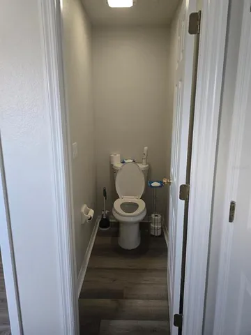 a bathroom with a toilet and a mirror