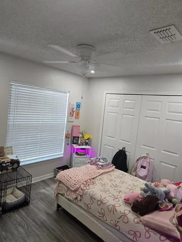 a bedroom with bed and a window