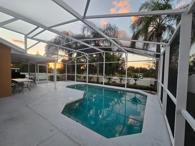 a view of a backyard with sitting area