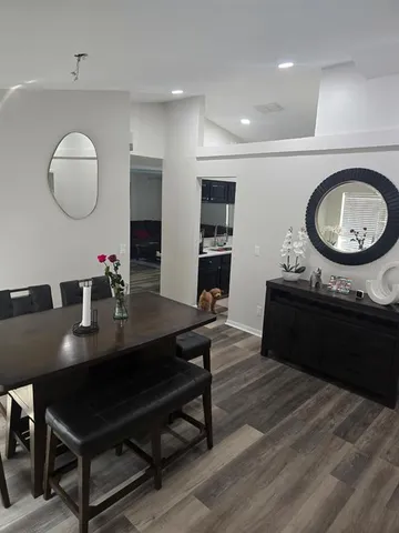 a living room with furniture and a mirror