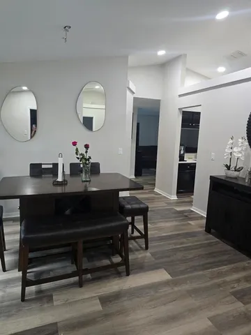 a living room with furniture and a wooden floor