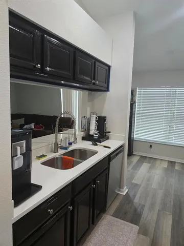 a kitchen with a sink a stove and cabinets
