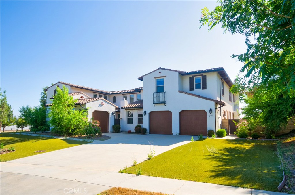 245 Snapdragon Lane Glendora, CA 91741 - Photo 1 of 42 a view of a white house with a swimming pool and lawn chairs under an umbrella