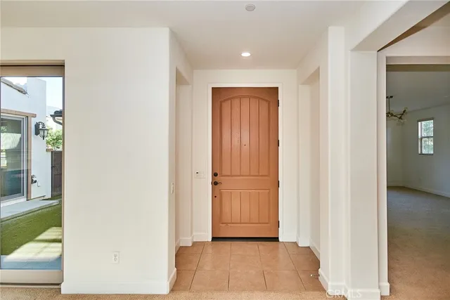 an empty room with a fireplace and cabinet