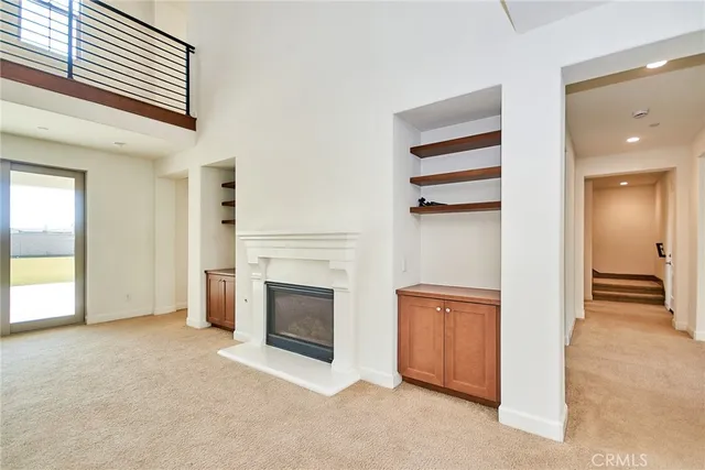 a large kitchen with stainless steel appliances kitchen island granite countertop a refrigerator and a stove top oven