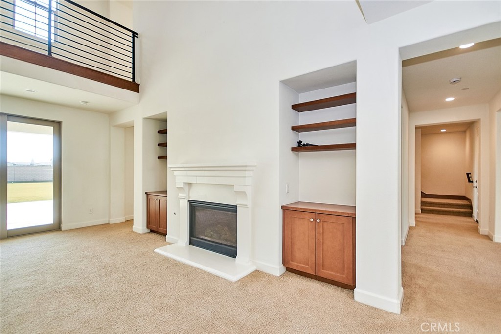 245 Snapdragon Lane Glendora, CA 91741 - Photo 18 of 42 an empty room with a fireplace and cabinet