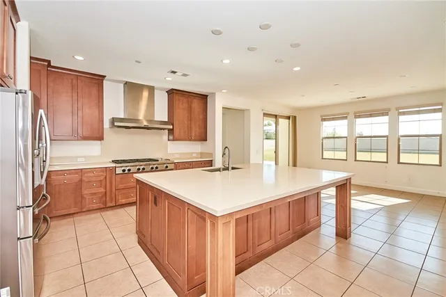 a kitchen with stainless steel appliances granite countertop a stove a sink and a refrigerator
