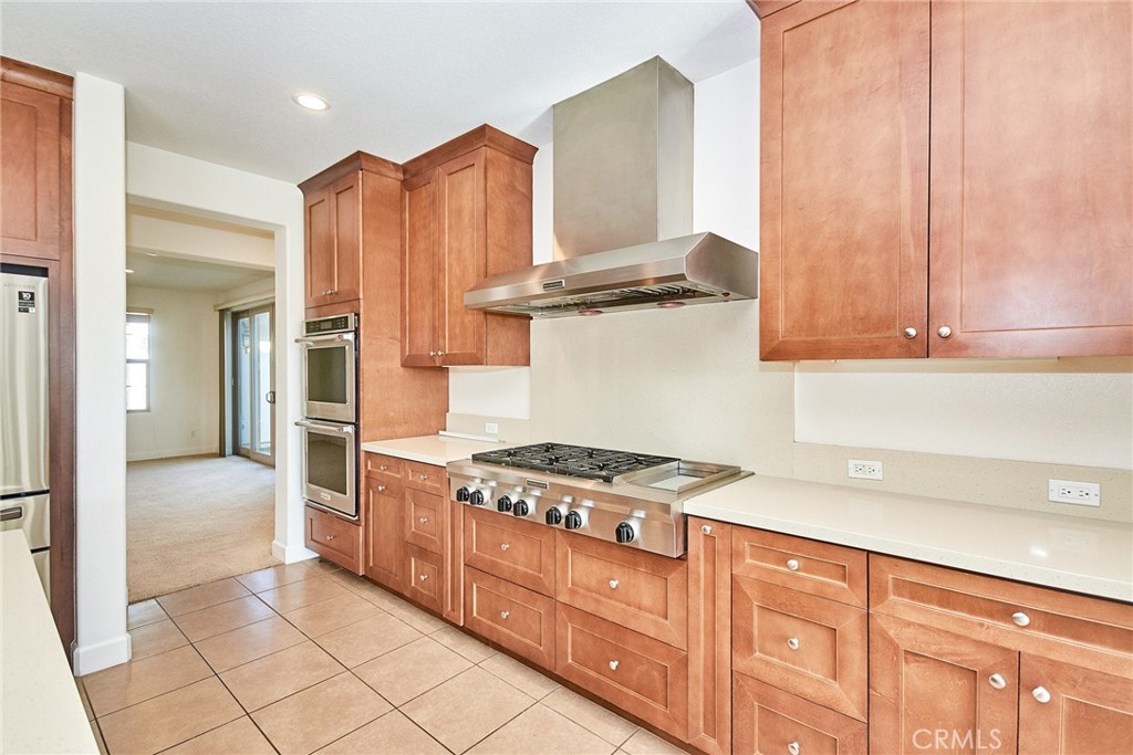 245 Snapdragon Lane Glendora, CA 91741 - Photo 22 of 42 a kitchen with stainless steel appliances granite countertop a stove a sink and a refrigerator