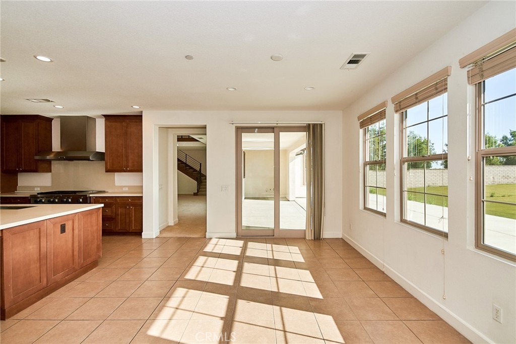 245 Snapdragon Lane Glendora, CA 91741 - Photo 23 of 42 a view of a kitchen with stainless steel appliances granite countertop a large window and a refrigerator