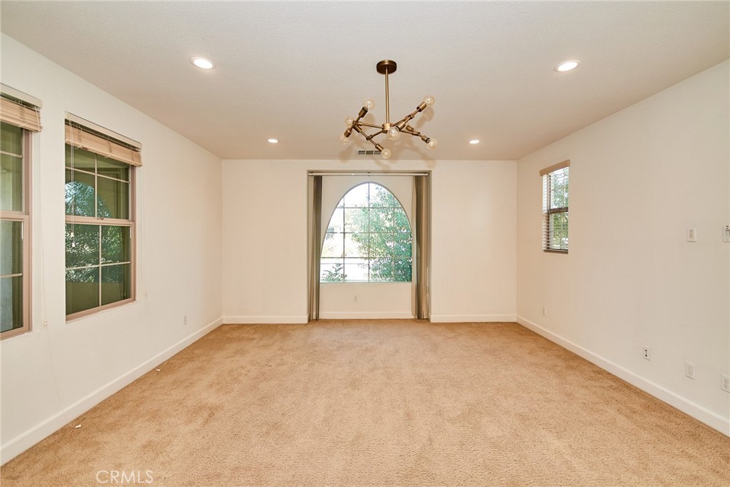 245 Snapdragon Lane Glendora, CA 91741 - Photo 26 of 42 en empty room with windows and chandelier