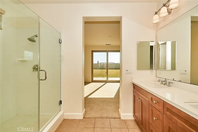 a spacious bathroom with a sink and a mirror