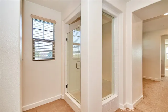 a bathroom with a granite countertop sink a toilet and shower
