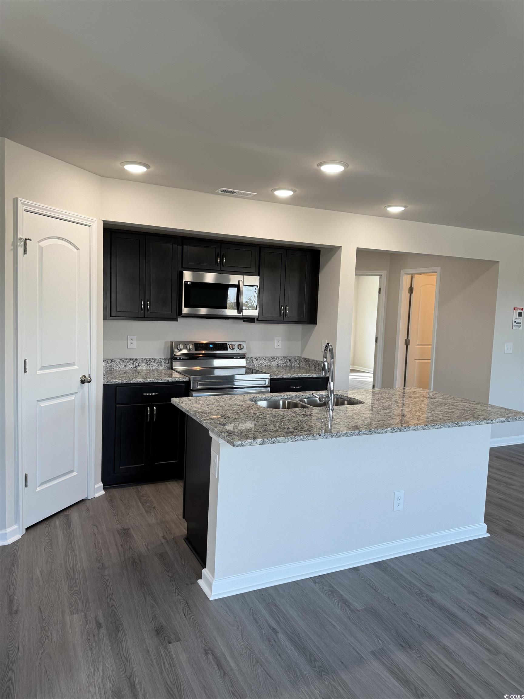 819 Busy Corner Road Conway, SC 29527 - Photo 7 of 24 Kitchen with a sink, light stone countertops, dark