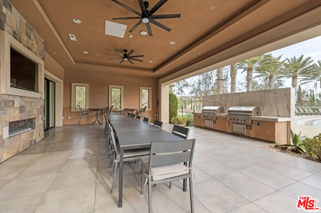 20763 Pine Cone Circle Porter Ranch, CA 91326 - Photo 12 of 20 a dining room with furniture a chandelier and fireplace