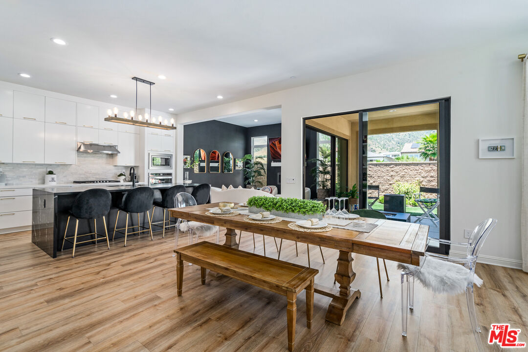 20763 Pine Cone Circle Porter Ranch, CA 91326 - Photo 3 of 20 a view of a dining room with furniture window and wooden floor