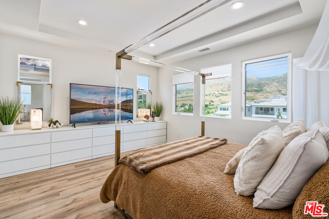 20763 Pine Cone Circle Porter Ranch, CA 91326 - Photo 8 of 20 a spacious bedroom with a large bed and a large window