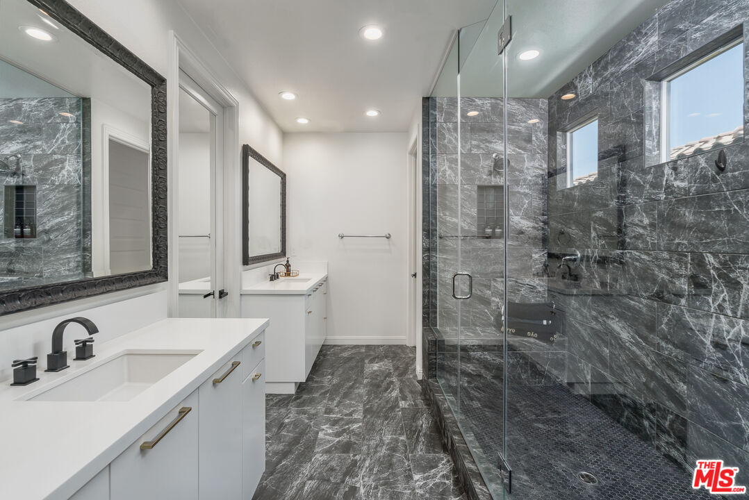 20763 Pine Cone Circle Porter Ranch, CA 91326 - Photo 9 of 20 a bathroom with a double vanity sink mirror and shower
