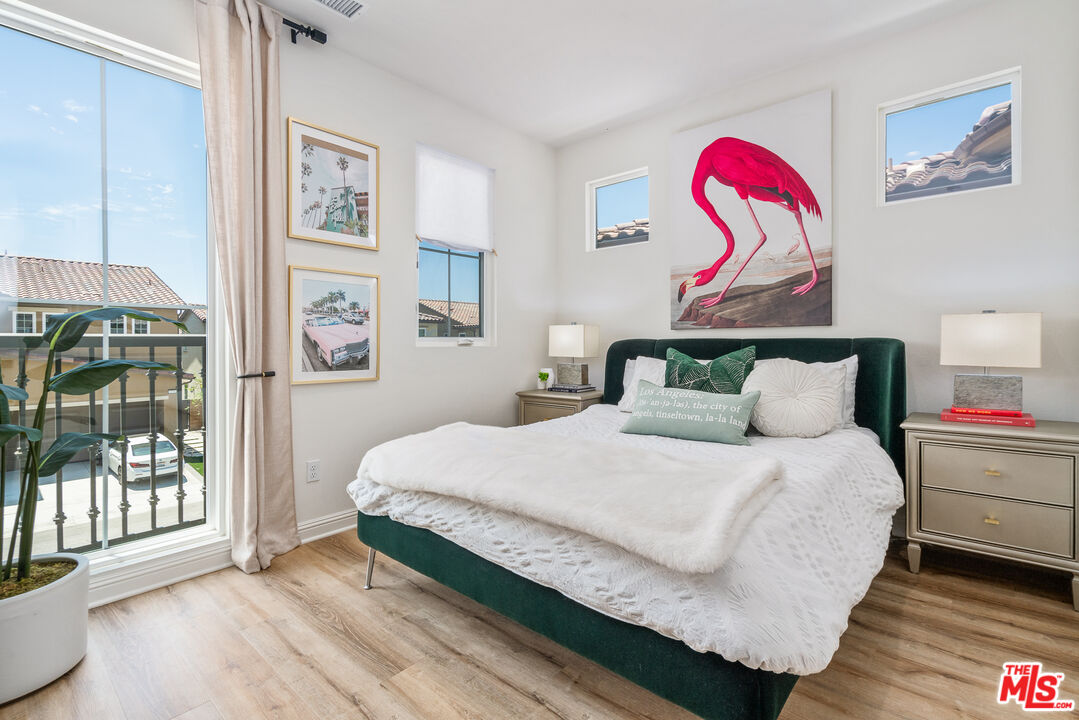 20763 Pine Cone Circle Porter Ranch, CA 91326 - Photo 10 of 20 a bedroom with a bed and a painting on the wall