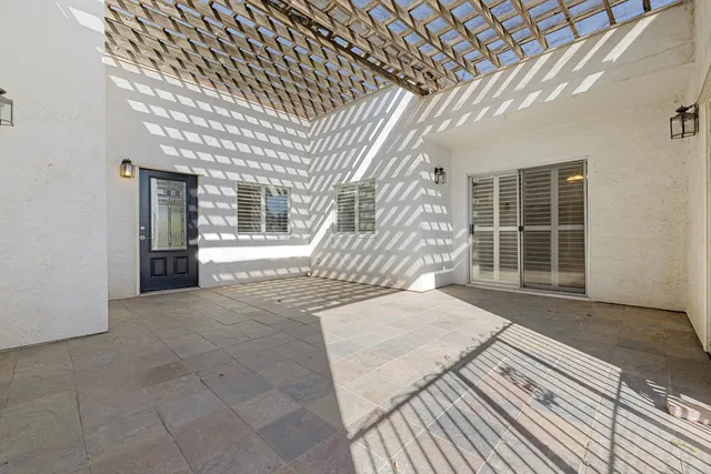 a view of a porch with wooden floor and fence