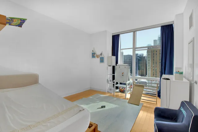 a bedroom with a bed and a table