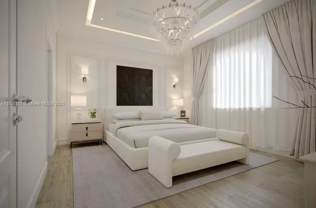 a spacious bedroom with a bed and a chandelier