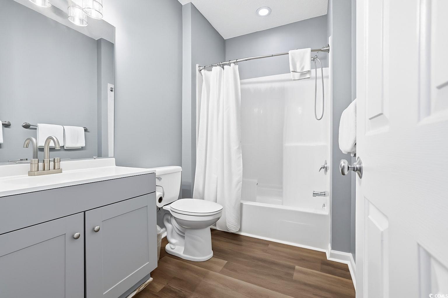 4541 Girvan Drive, Unit B Myrtle Beach, SC 29579 - Photo 20 of 29 Bathroom featuring vanity, dark wood-type flooring, and shower / bath combo with shower curtain