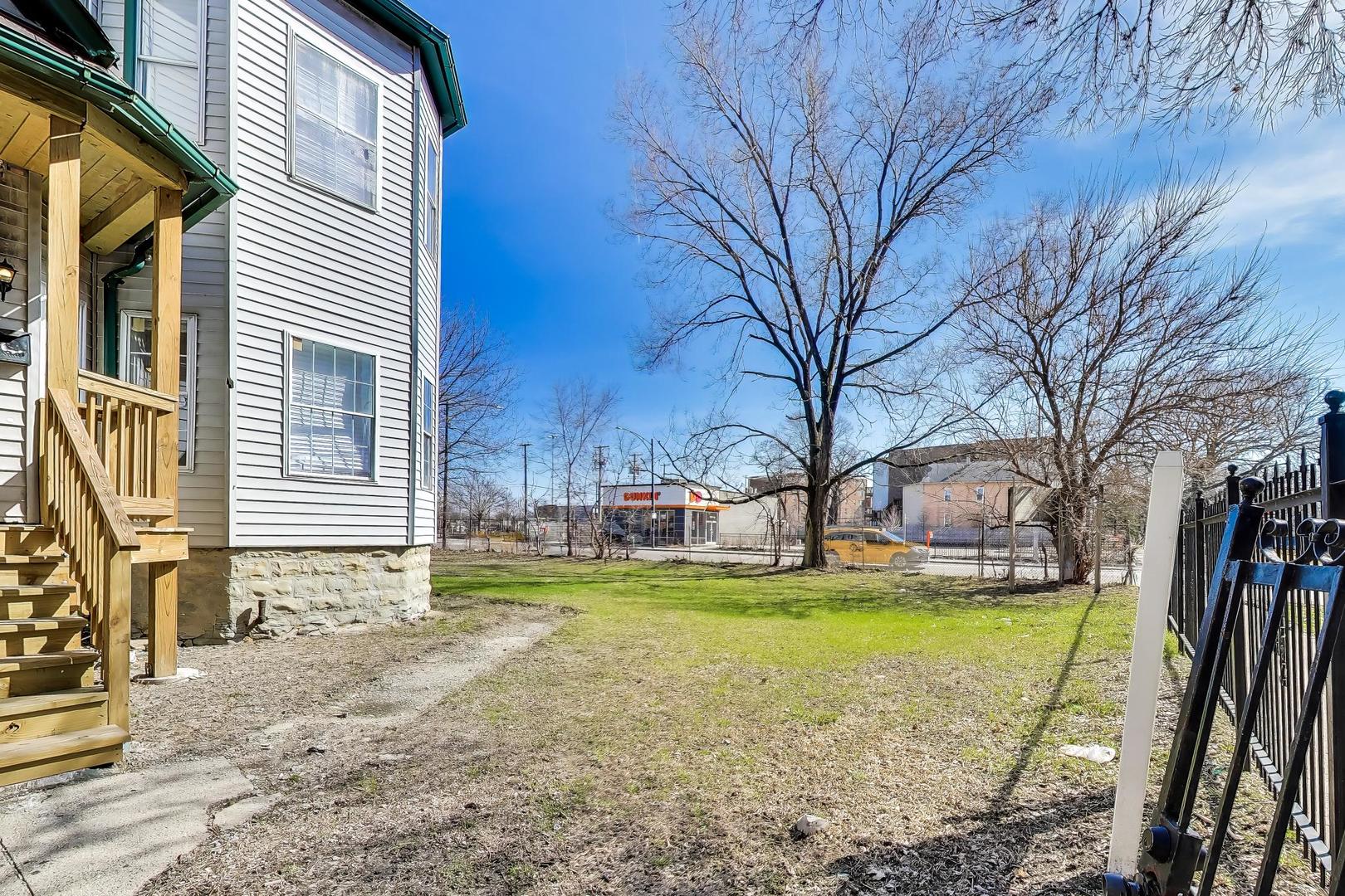 6853 South Perry Avenue Chicago, IL 60621 - Photo 3 of 28 a view of a house with a yard