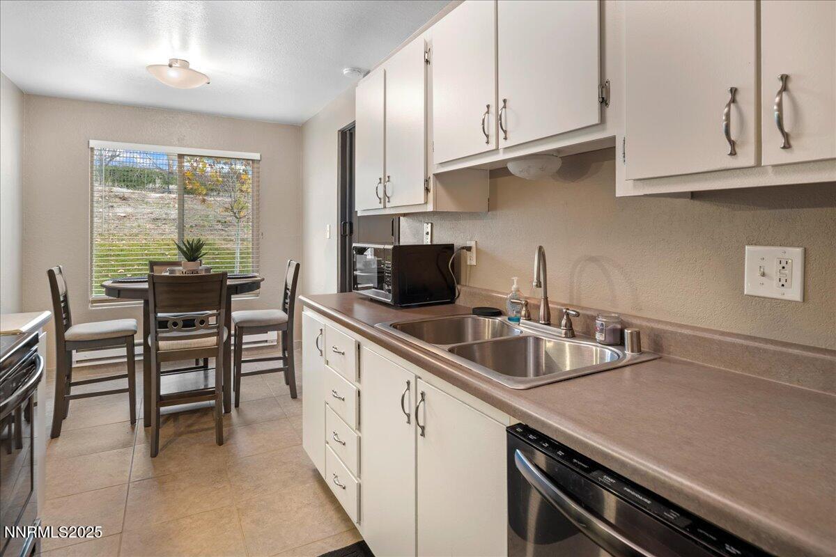3941 Clear Acre Lane, Unit 237 Reno, NV 89512 - Photo 11 of 26 a kitchen with granite countertop a sink and cabinets