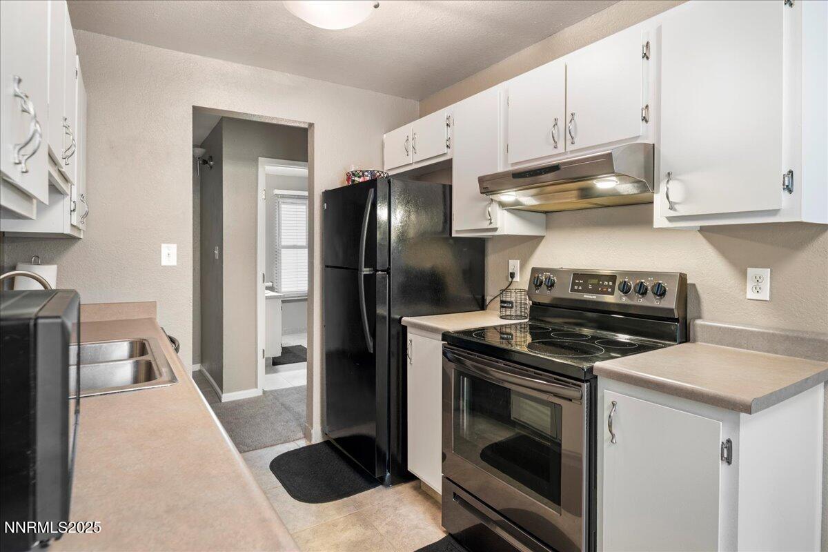 3941 Clear Acre Lane, Unit 237 Reno, NV 89512 - Photo 13 of 26 a kitchen with a stove and a refrigerator