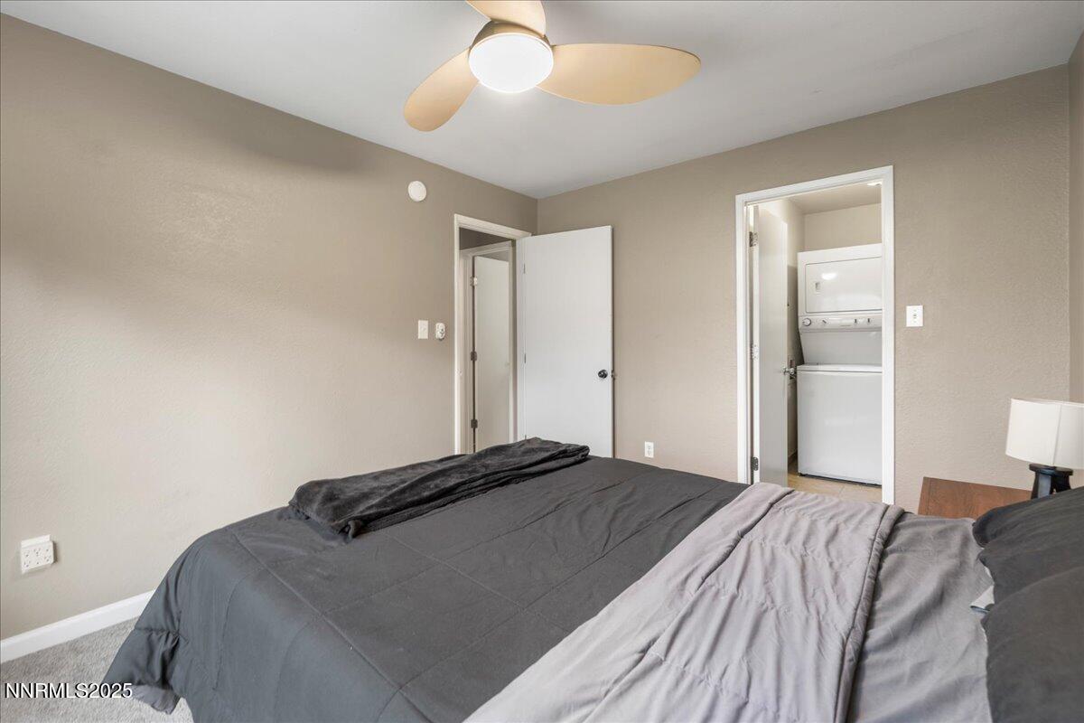 3941 Clear Acre Lane, Unit 237 Reno, NV 89512 - Photo 15 of 26 a bedroom with a bed and a chandelier